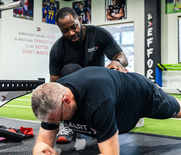 a guy doing exercise with his trainer